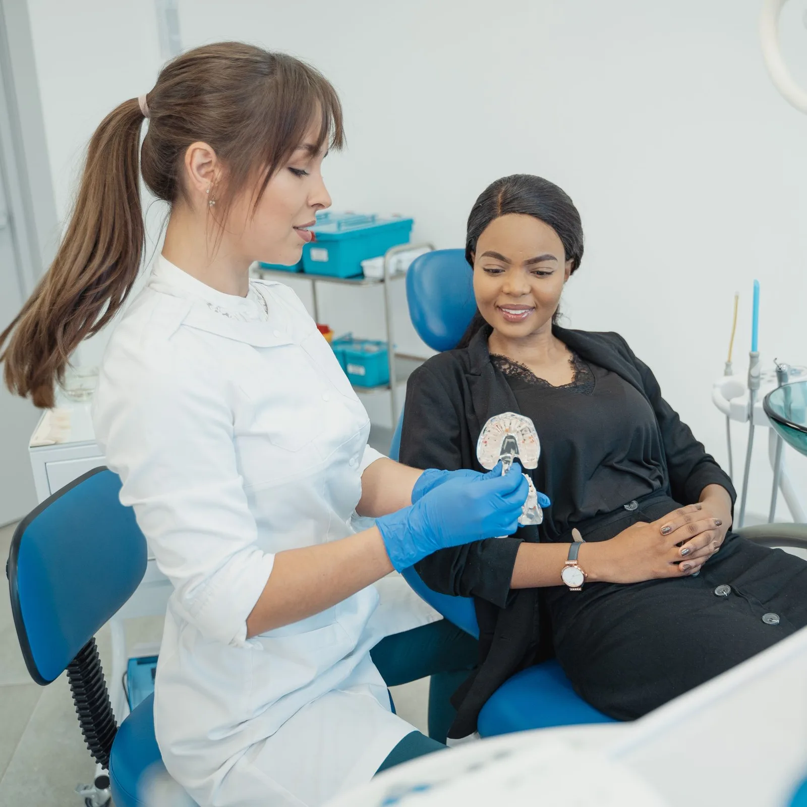 Dentist smiling at a patient in the chair.