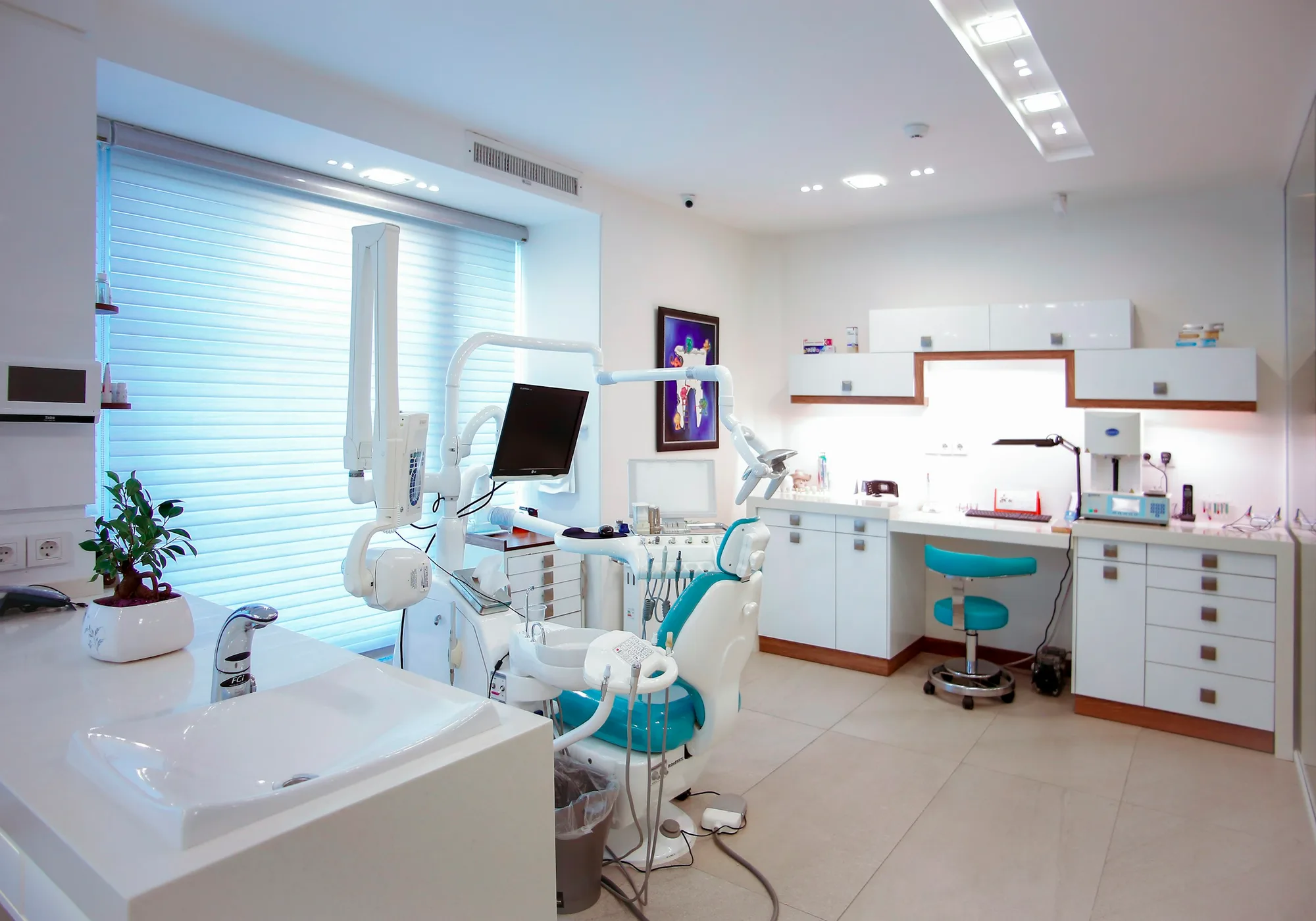Dental office with a patient chair and an X-ray display.