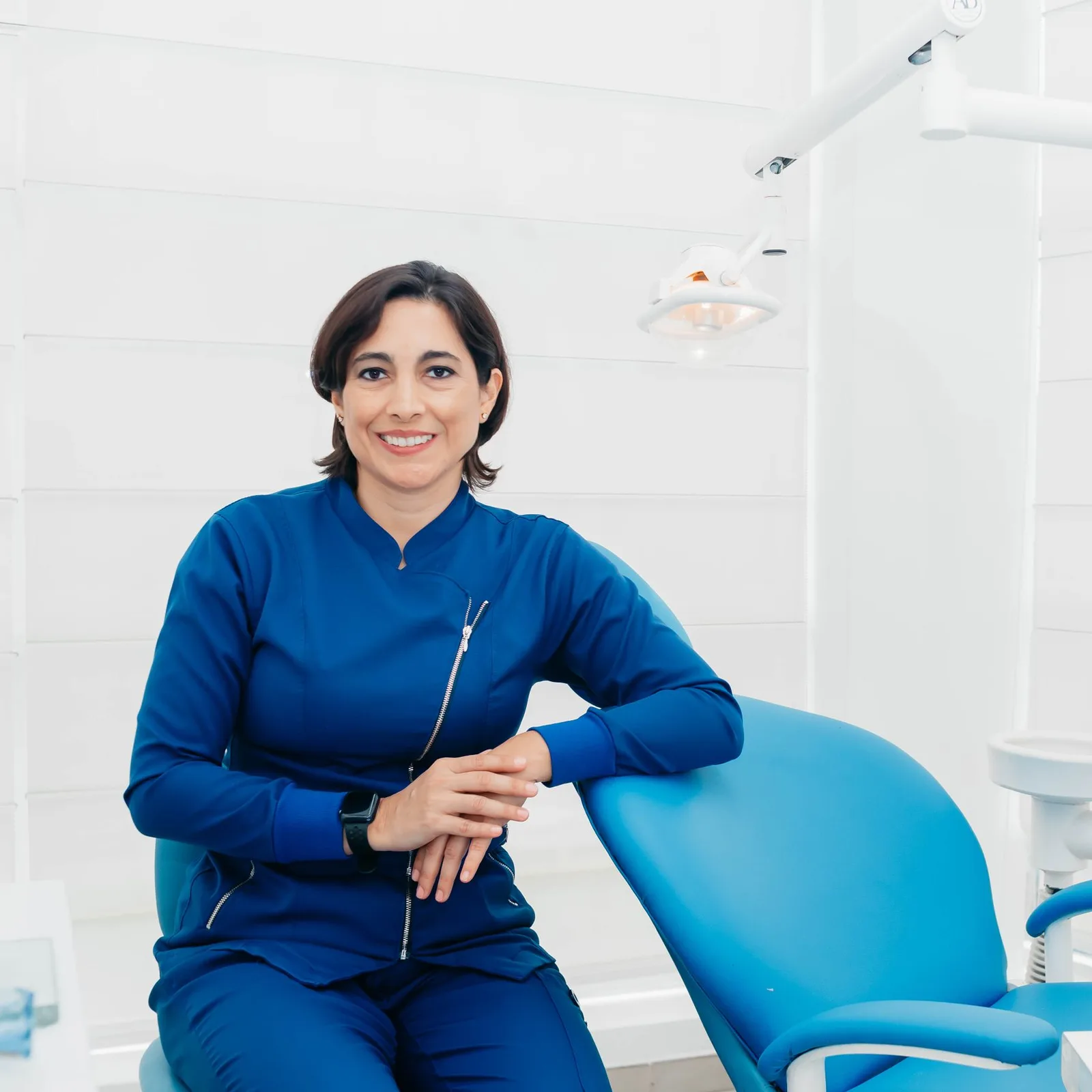 Smiling dental professional giving a thumbs up.